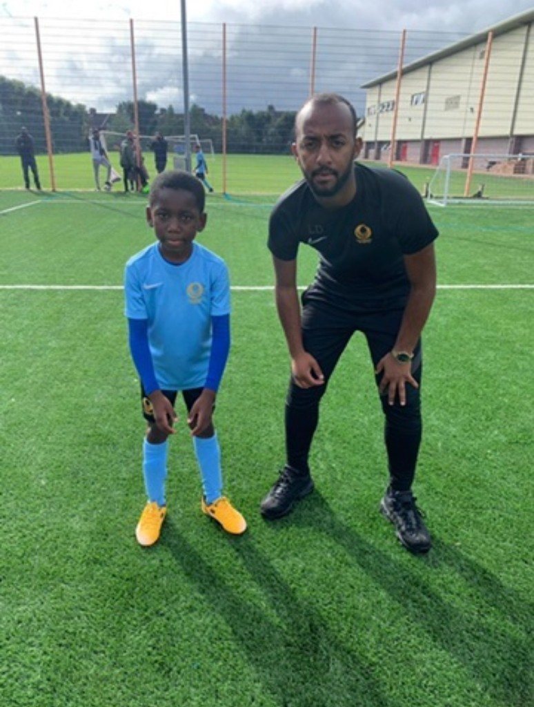 A coach with a young grassroots player