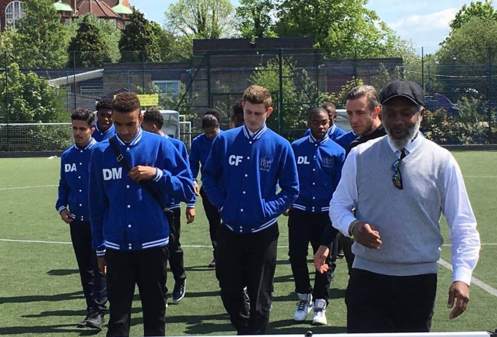Players in varsity jackets walking onto the pitch