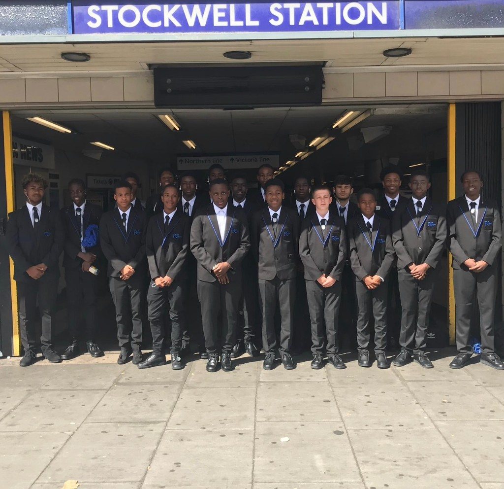 A squad in club blazers outside Stockwell station